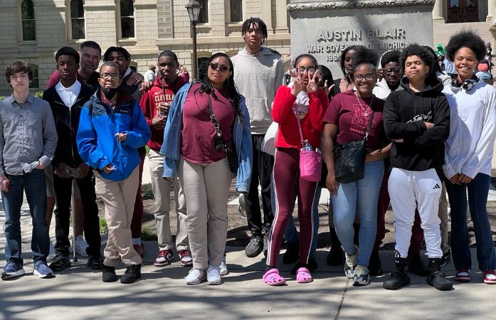  Students posing in front of the Michigan state capital for Lobby Day 2024
